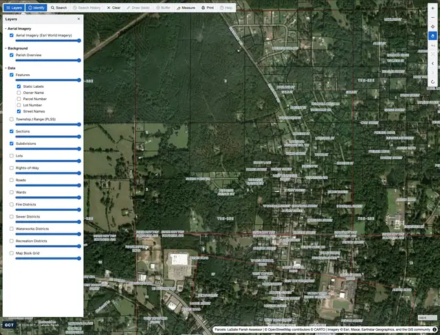 Classic viewer: aerial imagery with a top toolbar and a layers panel listing parcels, sections, subdivisions, and districts with per-layer opacity sliders